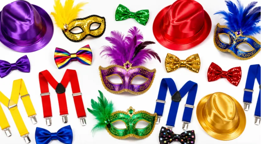 Colorful assortment of carnival masks, hats, bow ties, and suspenders on a white background