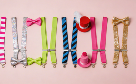 Colorful carnival party suspenders and matching bow ties flat lay.